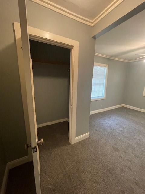 2120 68th Ter, Kansas City, MO 64132 - unfurnished bedroom featuring carpet flooring, baseboards, and ornamental molding