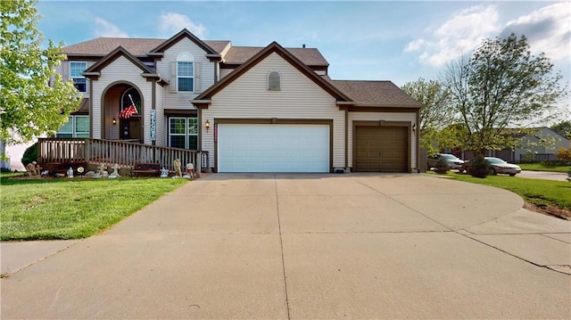 traditional-style home with a garage, a front lawn, and driveway