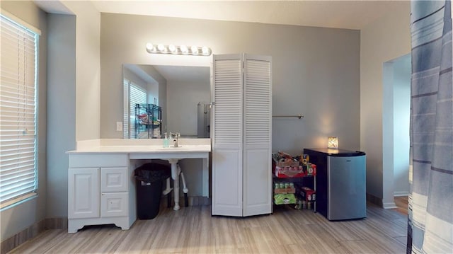 bathroom with baseboards and wood finished floors
