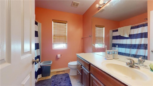 full bath featuring toilet, visible vents, a healthy amount of sunlight, and vanity