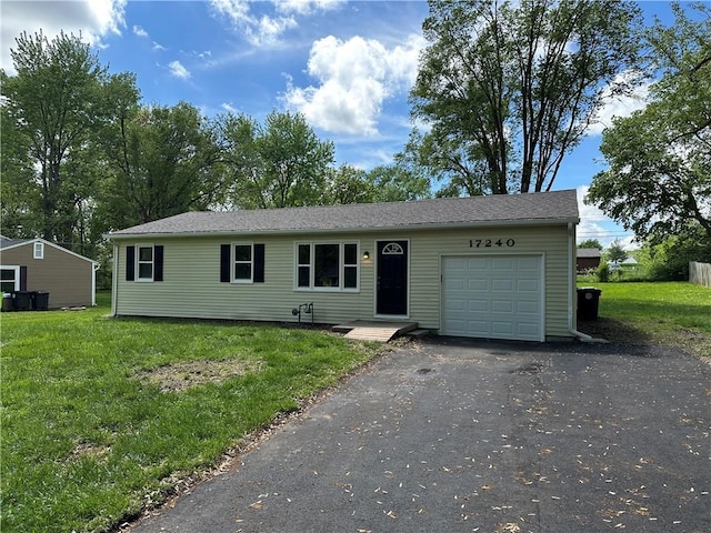 ranch-style home with a garage, driveway, and a front yard