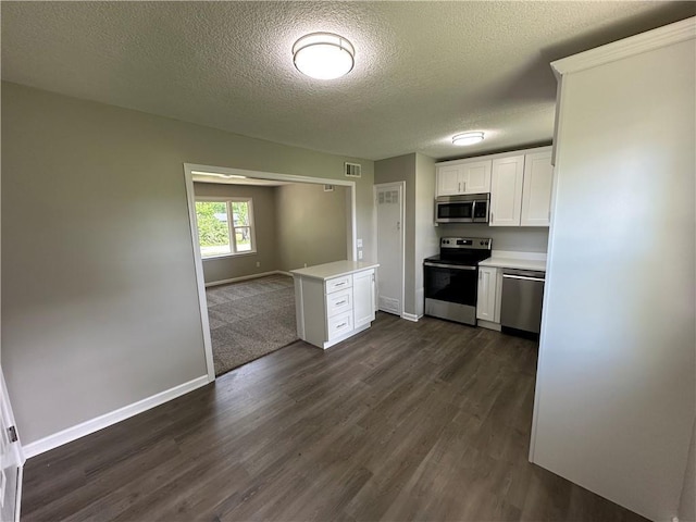 kitchen featuring white cabinets, appliances with stainless steel finishes, light countertops, a textured ceiling, and visible vents