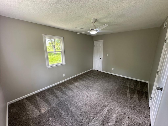 unfurnished bedroom featuring carpet flooring, a textured ceiling, ceiling fan, and baseboards