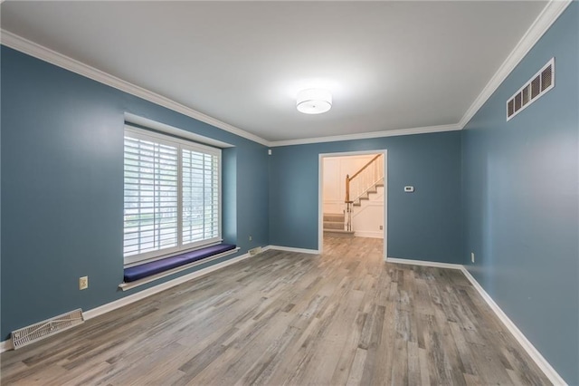 11801 Avila Dr, Kansas City, MO 64114 - empty room featuring wood finished floors, stairs, and crown molding