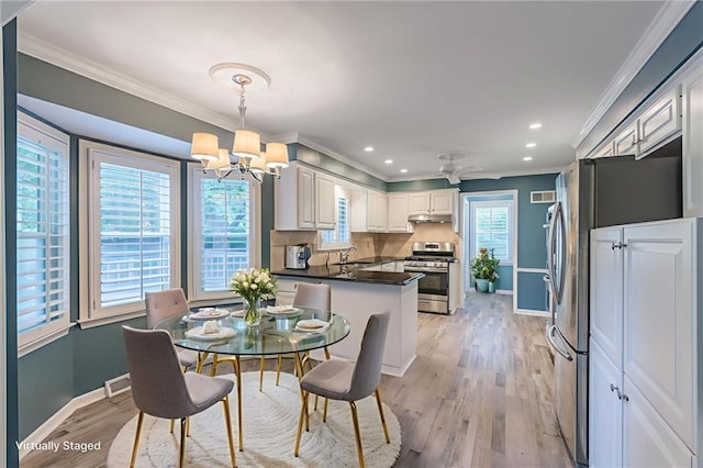 11801 Avila Dr, Kansas City, MO 64114 - dining room featuring a chandelier, ornamental molding, light wood-style floors, recessed lighting, and ceiling fan