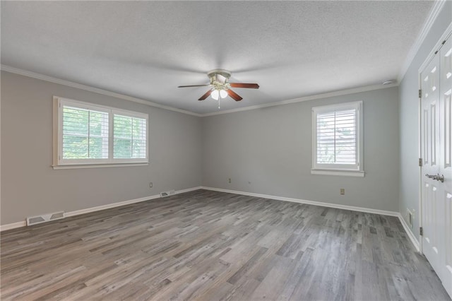 11801 Avila Dr, Kansas City, MO 64114 - unfurnished room featuring a ceiling fan, healthy amount of natural light, wood finished floors, a textured ceiling, and crown molding