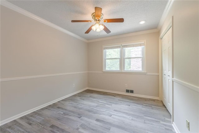 11801 Avila Dr, Kansas City, MO 64114 - unfurnished bedroom featuring a textured ceiling, light wood-style flooring, ornamental molding, ceiling fan, and a closet