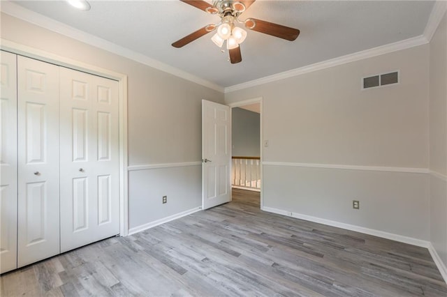11801 Avila Dr, Kansas City, MO 64114 - unfurnished bedroom with wood finished floors, ornamental molding, a closet, and ceiling fan