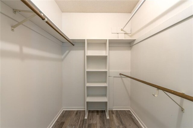 11801 Avila Dr, Kansas City, MO 64114 - walk in closet featuring wood finished floors