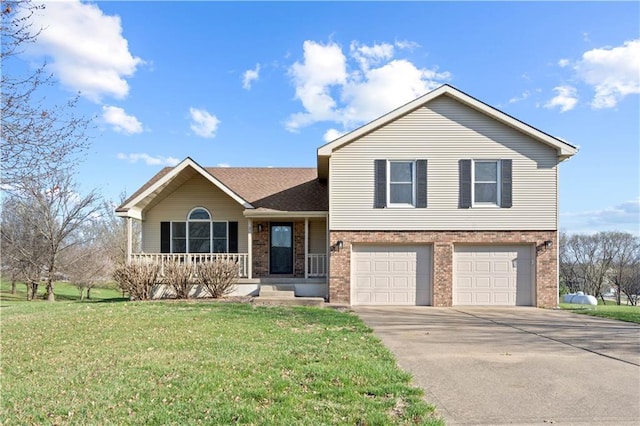 tri-level home featuring an attached garage, concrete driveway, a front lawn, a porch, and brick siding