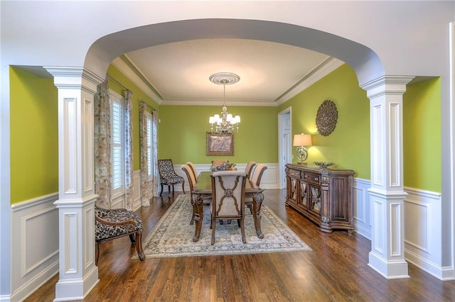 5701 W 148th Pl, Overland Park, KS 66223 - dining space with arched walkways, decorative columns, a decorative wall, dark wood-type flooring, and wainscoting