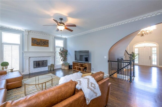 5701 W 148th Pl, Overland Park, KS 66223 - living area with arched walkways, healthy amount of natural light, and wood finished floors
