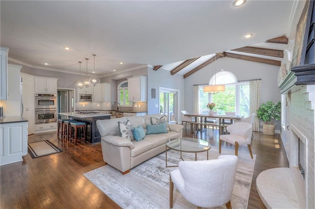 5701 W 148th Pl, Overland Park, KS 66223 - living room with a fireplace, dark wood-style flooring, recessed lighting, and a chandelier