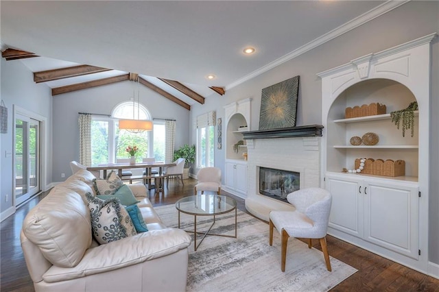 5701 W 148th Pl, Overland Park, KS 66223 - living area with wood finished floors, a glass covered fireplace, built in shelves, and recessed lighting