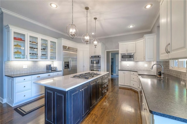 5701 W 148th Pl, Overland Park, KS 66223 - kitchen featuring built in appliances, white cabinets, tasteful backsplash, recessed lighting, and ornamental molding