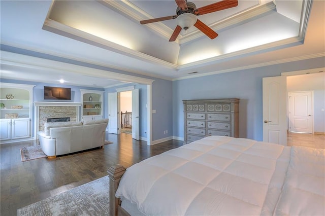 5701 W 148th Pl, Overland Park, KS 66223 - bedroom with a tray ceiling, ornamental molding, wood finished floors, and a fireplace