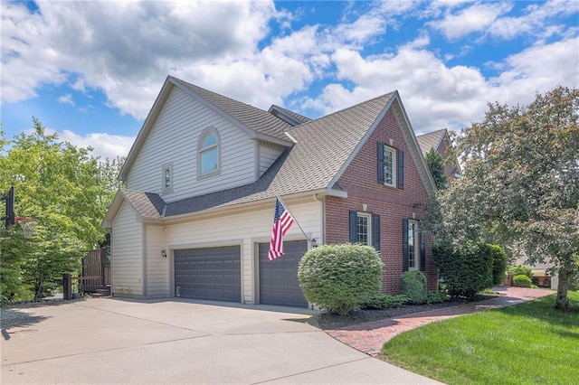 5701 W 148th Pl, Overland Park, KS 66223 - view of front of house with concrete driveway, an attached garage, brick siding, and roof with shingles