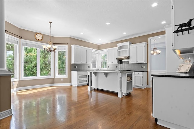 7406 W 145th Ter, Overland Park, KS 66223 - kitchen featuring a chandelier, open shelves, white cabinets, tasteful backsplash, and crown molding