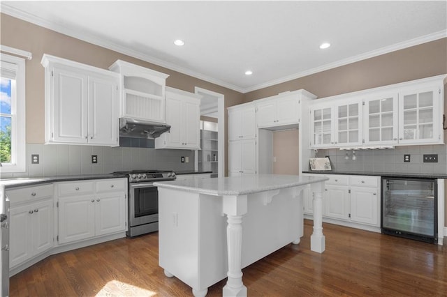7406 W 145th Ter, Overland Park, KS 66223 - kitchen with wine cooler, stainless steel gas stove, under cabinet range hood, white cabinets, and backsplash