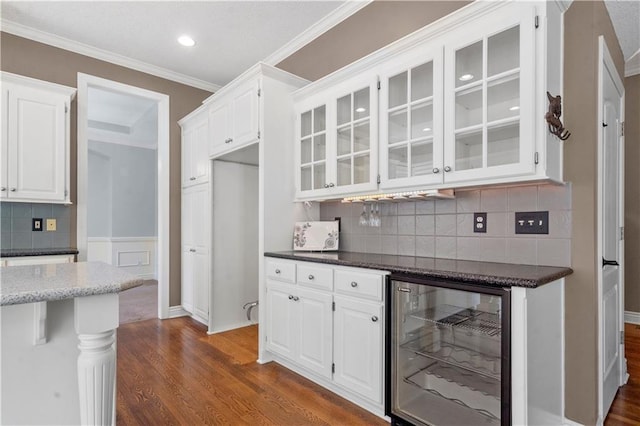 7406 W 145th Ter, Overland Park, KS 66223 - kitchen with beverage cooler, dark wood finished floors, glass insert cabinets, white cabinets, and tasteful backsplash