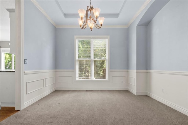 7406 W 145th Ter, Overland Park, KS 66223 - spare room featuring a tray ceiling, a chandelier, a wainscoted wall, and carpet