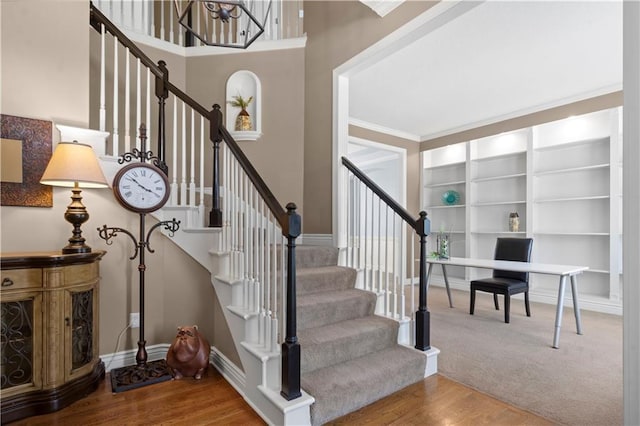 7406 W 145th Ter, Overland Park, KS 66223 - stairs featuring built in features, wood finished floors, crown molding, and baseboards