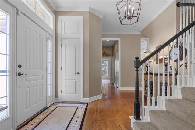 7406 W 145th Ter, Overland Park, KS 66223 - foyer featuring stairway, baseboards, a chandelier, ornamental molding, and wood finished floors