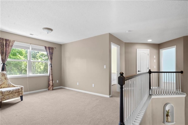 7406 W 145th Ter, Overland Park, KS 66223 - sitting room featuring a textured ceiling, light carpet, and baseboards