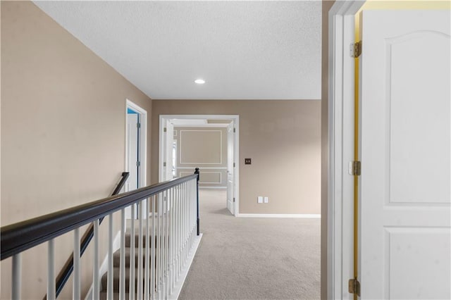 7406 W 145th Ter, Overland Park, KS 66223 - hallway with carpet flooring, baseboards, recessed lighting, a textured ceiling, and an upstairs landing