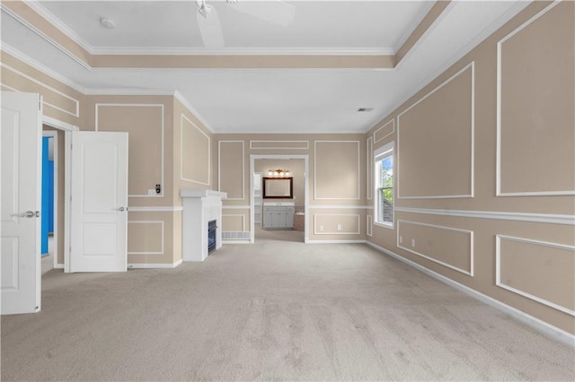 7406 W 145th Ter, Overland Park, KS 66223 - unfurnished living room featuring a decorative wall, carpet floors, crown molding, a fireplace, and ceiling fan
