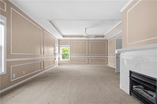 7406 W 145th Ter, Overland Park, KS 66223 - unfurnished living room featuring a decorative wall, a tile fireplace, ceiling fan, ornamental molding, and light colored carpet