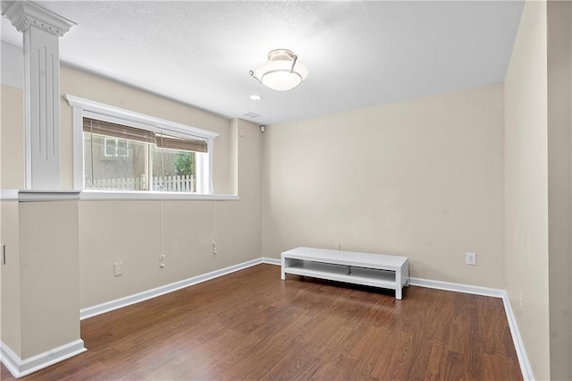 7406 W 145th Ter, Overland Park, KS 66223 - spare room with wood finished floors, baseboards, and a textured ceiling