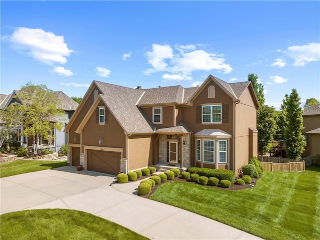 7406 W 145th Ter, Overland Park, KS 66223 - view of front facade with stucco siding, stone siding, an attached garage, and driveway