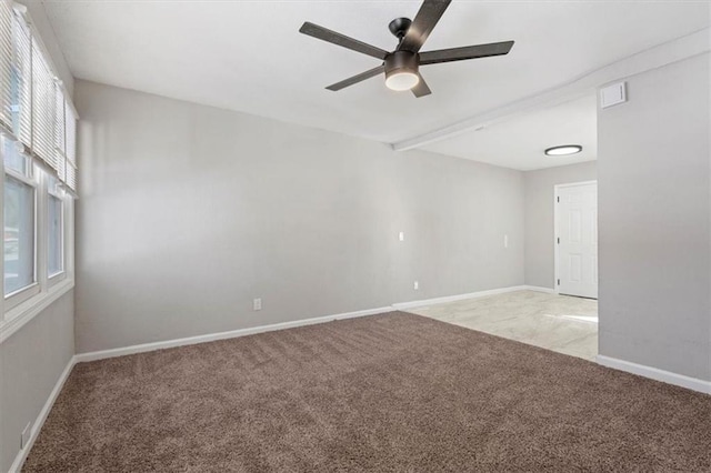 spare room with baseboards, a ceiling fan, and light colored carpet