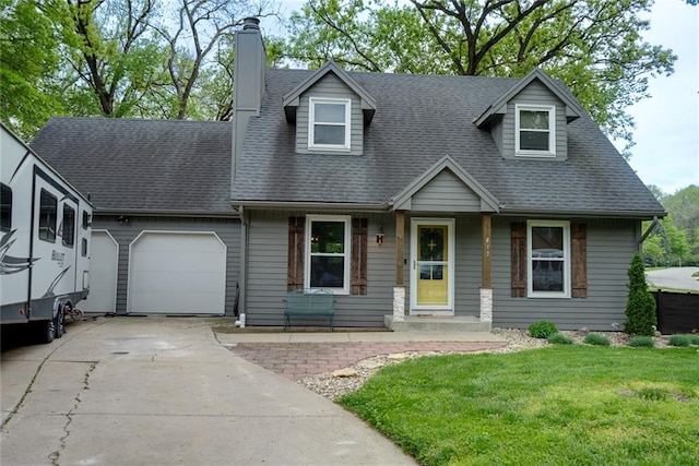 cape cod house featuring a front lawn, a chimney, a shingled roof, an attached garage, and driveway