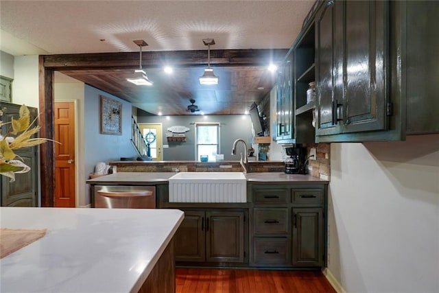 kitchen featuring open shelves, a sink, a peninsula, dark wood-type flooring, and stainless steel dishwasher