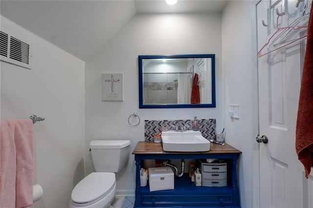 full bath with visible vents, tile patterned flooring, vaulted ceiling, vanity, and toilet