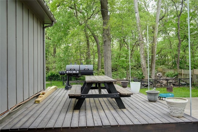 wooden terrace with fence and outdoor dining space