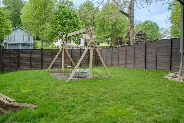 view of play area with a lawn, a fenced backyard, and a vegetable garden