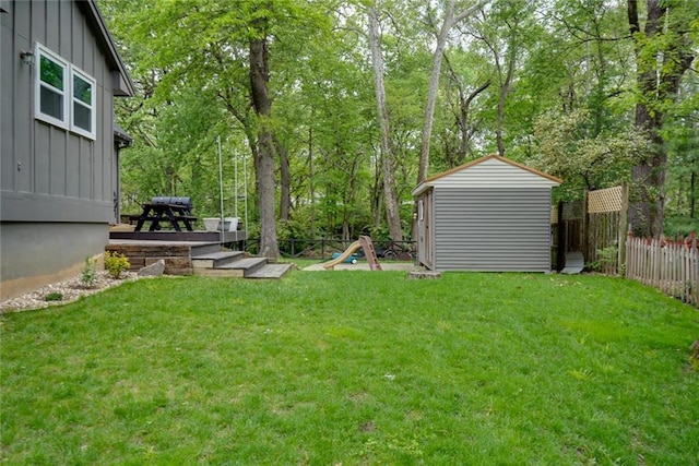 view of yard featuring a storage shed, an outbuilding, and a fenced backyard