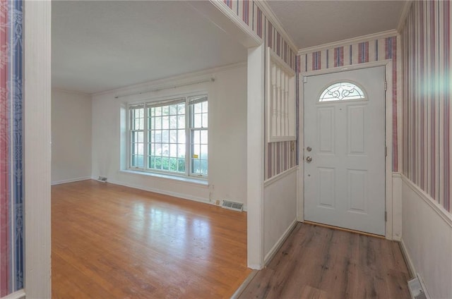 3913 Stonewall Ave, Independence, MO 64055 - foyer featuring crown molding, baseboards, visible vents, and wood finished floors