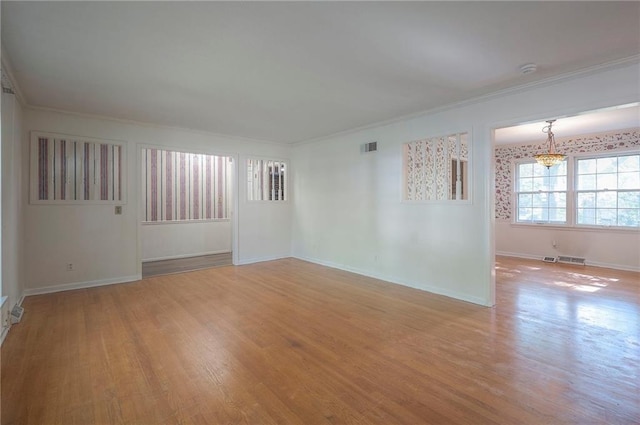3913 Stonewall Ave, Independence, MO 64055 - unfurnished room with visible vents, wood finished floors, baseboards, a chandelier, and ornamental molding