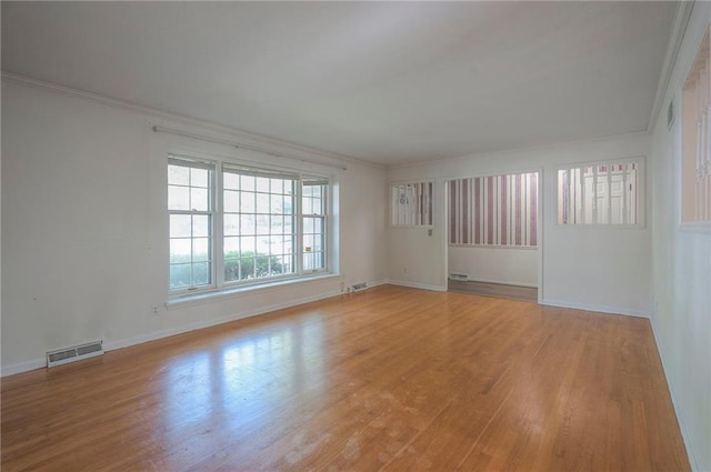 3913 Stonewall Ave, Independence, MO 64055 - empty room with baseboards, ornamental molding, wood finished floors, and visible vents