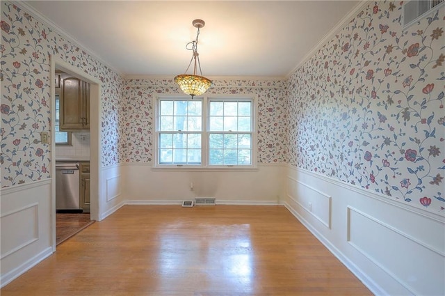 3913 Stonewall Ave, Independence, MO 64055 - unfurnished dining area with light wood-style floors, wainscoting, visible vents, and wallpapered walls