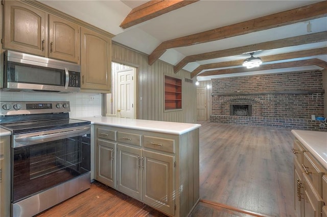 3913 Stonewall Ave, Independence, MO 64055 - kitchen with appliances with stainless steel finishes, a fireplace, light countertops, a peninsula, and wood finished floors