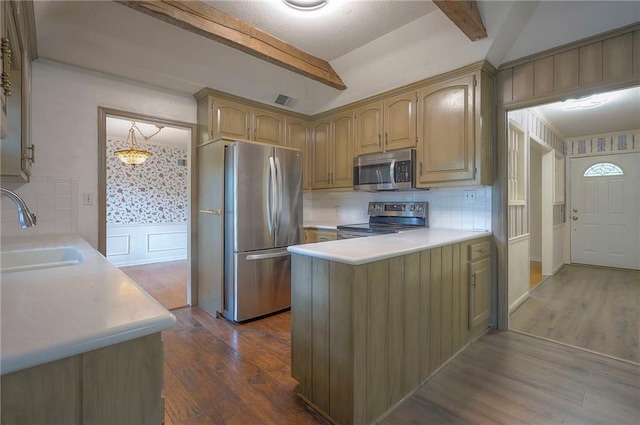 3913 Stonewall Ave, Independence, MO 64055 - kitchen with stainless steel appliances, beamed ceiling, decorative backsplash, and a sink