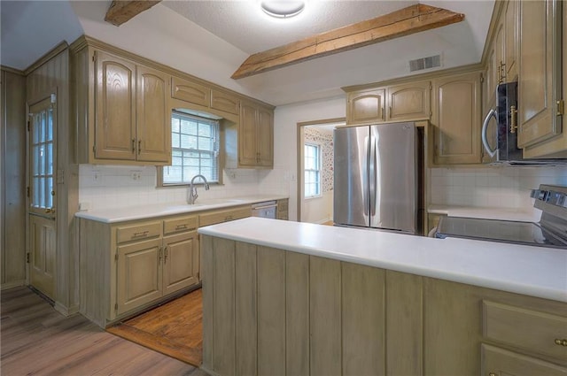 3913 Stonewall Ave, Independence, MO 64055 - kitchen with light countertops, appliances with stainless steel finishes, visible vents, and tasteful backsplash