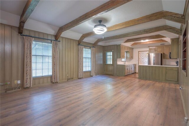 3913 Stonewall Ave, Independence, MO 64055 - unfurnished living room featuring a sink, light wood finished floors, ceiling fan, and beam ceiling