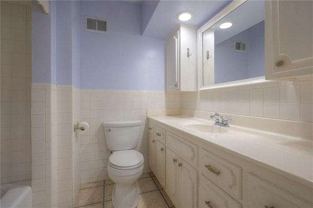 3913 Stonewall Ave, Independence, MO 64055 - bathroom with visible vents, wainscoting, toilet, and vanity