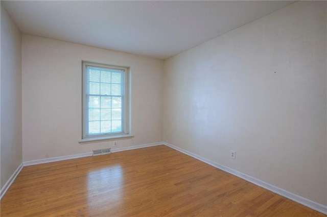 3913 Stonewall Ave, Independence, MO 64055 - unfurnished room featuring baseboards, visible vents, and wood finished floors